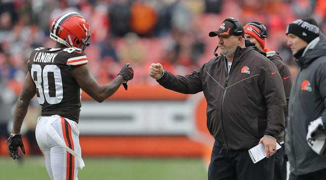 Browns wide receiver Jarvis Landry (80) fist bumps offensive coordinator Alex Van Pelt as he comes off the field during the second half of the Browns' 21-16 win over the Cincinnati Bengals in the season finale on Sunday. [Jeff Lange/Beacon Journal]