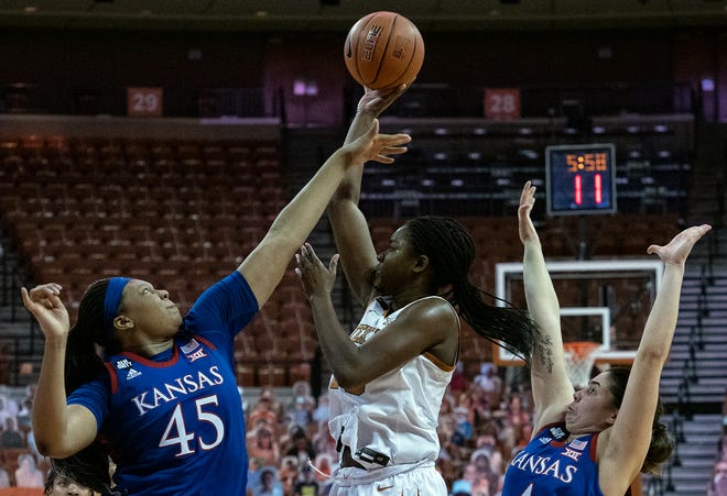 Texas' DeYona Gaston shoots past Kansas' Chisom Ajekwu during the first half of last season's game at the Erwin Center. The Jayhawks return for what will be their final game at the Erwin Center on Wednesday.
