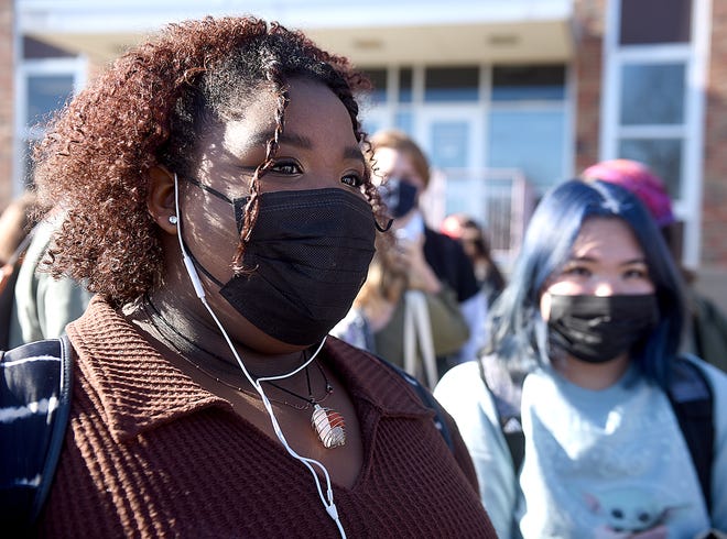 Hickman High School senior Desirae McCracken, 17, right, listens as senior Cami Williams, 17, co-organizer of a student walkout Monday, speaks in favor of a COVID-19 mask mandate in school. The Columbia school board voted to rescind its mask requirement inside school buildings last month. About 120 students participated in Monday's walkout to protest the decision.