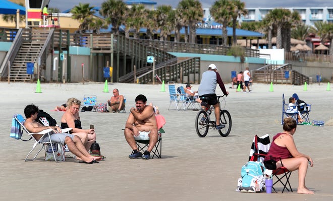 Beachgoers enjoy some sunshine in front of Sun Splash Park in Daytona Beach on Monday, just hours before a cold front made its way through the area. Cooler temps are forecast for the rest of the week.
