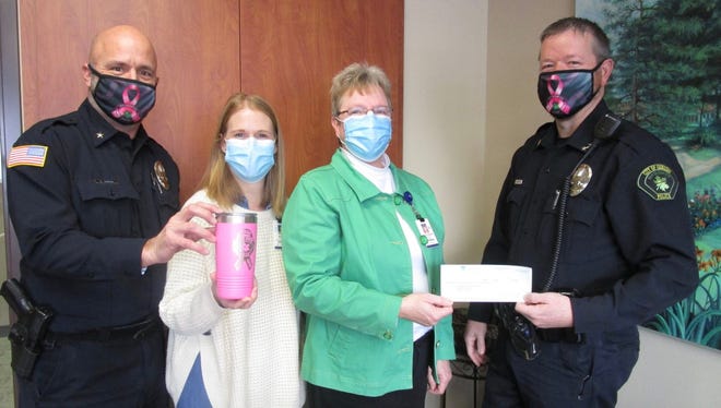 The Geneseo Police Department has been selling pink tumblers and masks to benefit the Hammond-Henry Hospital Foundation in their annual efforts to raise awareness of breast cancer. The Police Department employees raised over $1,970 from the sales. Police officers and hospital employees at a recent check presentation include, from left, Geneseo Deputy Chief of Police Gene Karzin, Katie Orwig, Hospital Foundation Assistant; Darcy Hepner, Hospital Foundation Manager; and Police Chief Casey Disterhoft. A limited number of tumblers and masks are still available at the Police Department and anyone interested is asked to stop at the Police Department, 119 South Oakwood Ave., or call the Department at 309-944-5141. The tumblers are $25 and masks are $5 each. Funds raised will be used in the Women’s Imaging Department at the hospital.