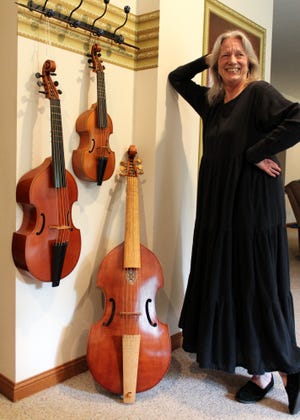 Wendy Gillespie, Alchymy member and a retired professor of viola da gamba at Indiana University's Jacobs School of Music, poses with different sizes of viola da gambas in a consort. Gillespie is one of several musicians who will be performing Feb. 6.