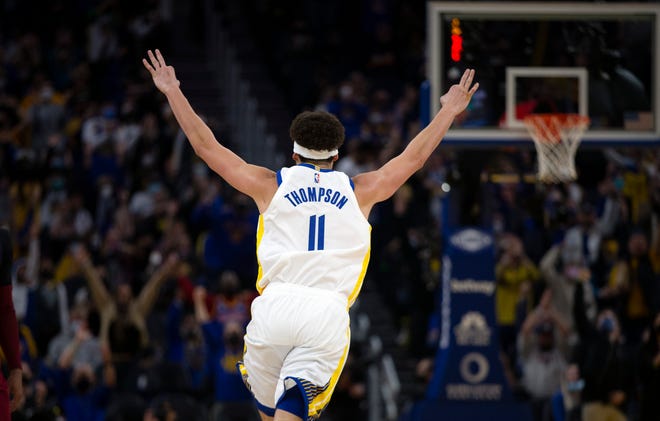 Warriors guard Klay Thompson (11) celebrates his 1800th career three-point basket during the third quarter against the Cleveland Cavaliers at Chase Center.