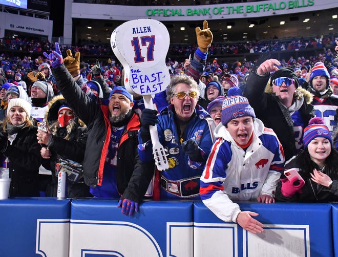 Jan 9, 2022; Orchard Park, New York, USA; Buffalo Bills fans celebrate winning the AFC East by gaining a win over the New York Jets at Highmark Stadium. Mandatory Credit: Mark Konezny-USA TODAY Sports