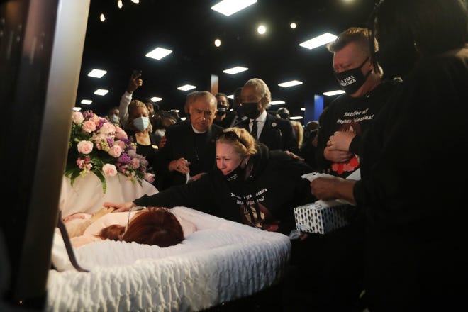 The Rev. Al Sharpton and mother Soledad Peralto grieve at the funeral for 14-year-old Valentina Orellana Peralta, killed on Dec. 23, by a LAPD police officer's stray bullet while shopping with her mother.