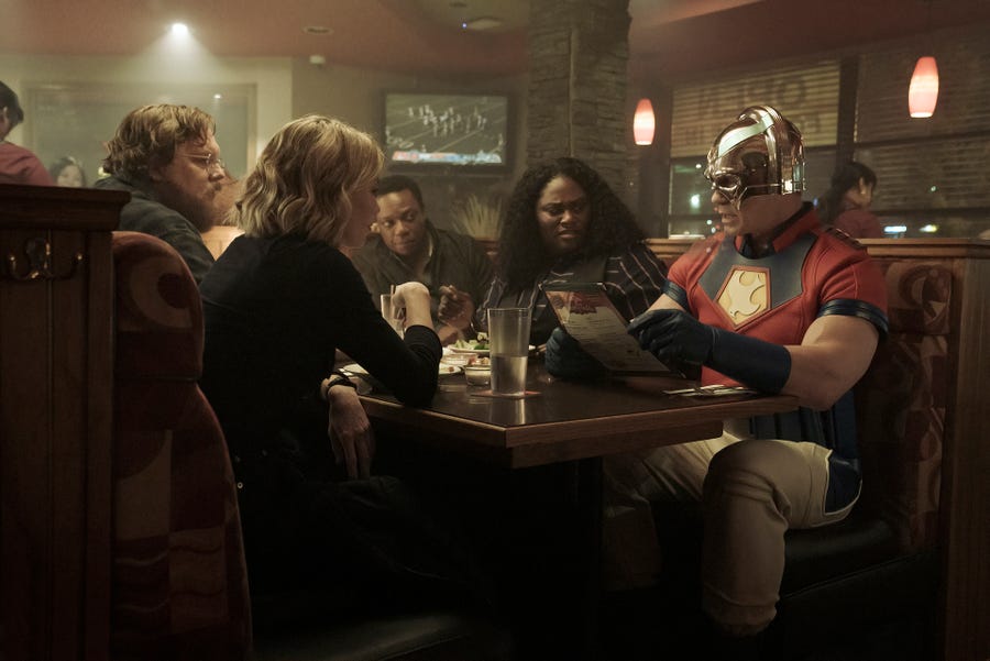 Peacemaker (John Cena, far right) has a rough first night out with his new team (including Steve Agee, Jennifer Holland, Chukwudi Iwuji and Danielle Brooks) in HBO Max's "Peacemaker."