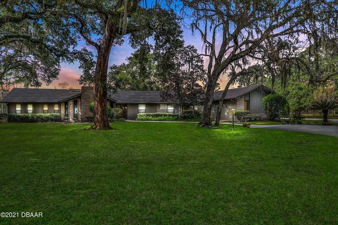 Sitting on 9.9 horse-friendly acres in Ormond Beach, this country estate has been carefully crafted with cathedral ceilings, exposed beams, beautiful stone and wood flooring.