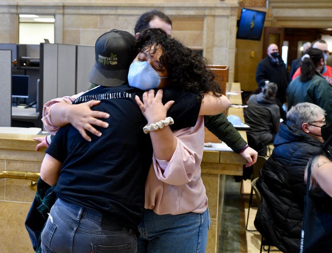 Indira Sheumaker, 27, hugs a supporter Monday, Jan. 10, 2022, before taking her seat on the Des Moines City Council.