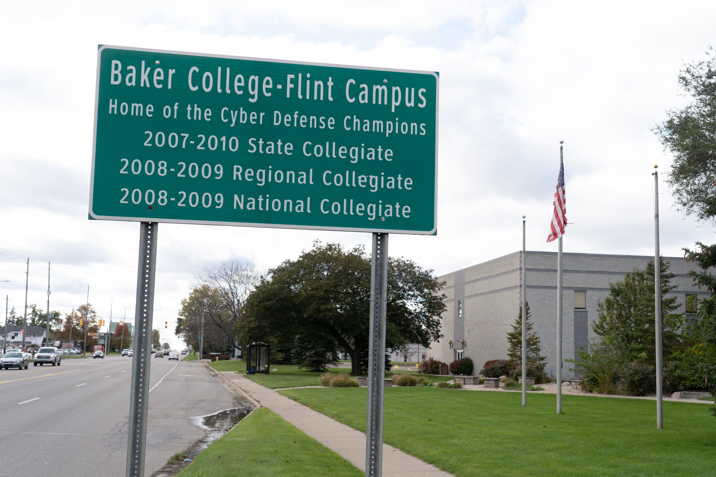 A sign for the Baker College Flint Campus touts the school's Cyber Defense Champions along Bristol Road in Flint outside of the former Baker College campus in Flint on Tuesday, October 26, 2021.