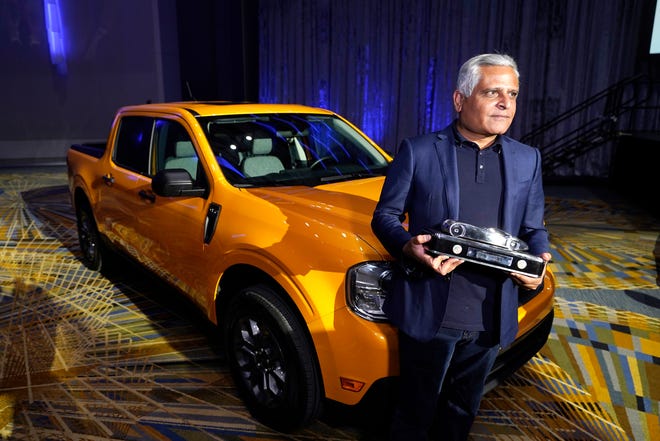 Kumar Galhotra, Ford President of the Americas and International markets group poses next to the Maverick compact pickup, Tuesday, Jan. 11 2022 in Detroit. For the second year in a row, vehicles from Ford Motor Co. took two of the three North American Car, Truck and Utility of the Year awards. The company's Maverick compact pickup won truck of the year.