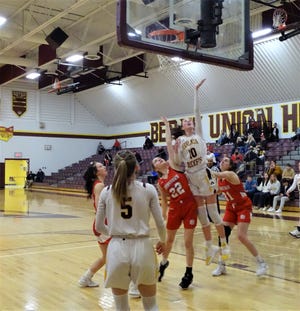 Berne Union's Sophia Kline lays in a shot over Johnstown's Liliana Townsend and Brooke Barb during a nonconference game Tuesday night. Kline scored 28 points to help lead the Rockets to a 44-38 win.