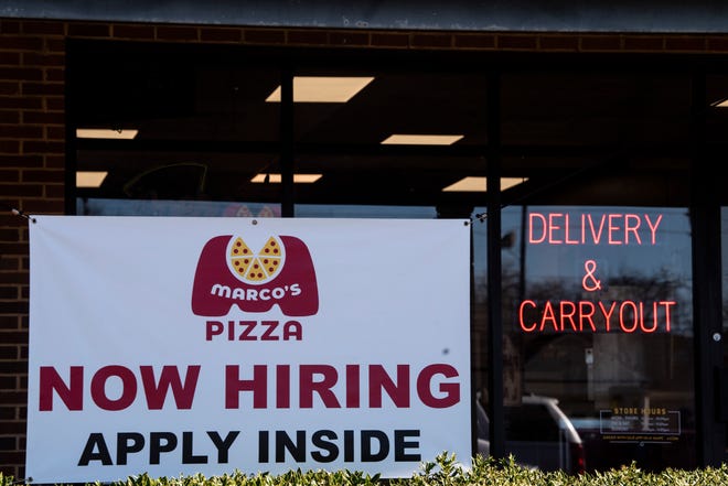 Now hiring sign on Perry Hill Road in Montgomery, Ala., on Tuesday, Jan. 11, 2022.