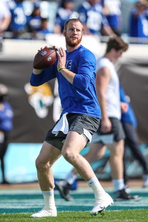 Indianapolis Colts quarterback Carson Wentz (2) throws a pass during warm-ups before of an NFL football game against the Jacksonville Jaguars, Sunday, Jan. 9, 2022, in Jacksonville, Fla. The Jaguars defeated the Colts 26-11. (AP Photo/Gary McCullough)