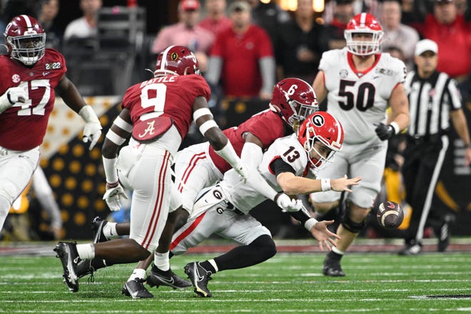 Georgia quarterback Stetson Bennett (13) recovers a fumble as he is tackled by Alabama defensive back Khyree Jackson (6) during the first quarter of the College Football Playoff national championship gam at Lucas Oil Stadium.