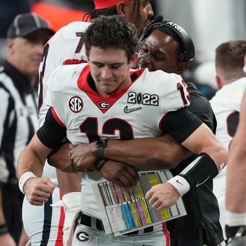 Georgia quarterback Stetson Bennett is hugged by a