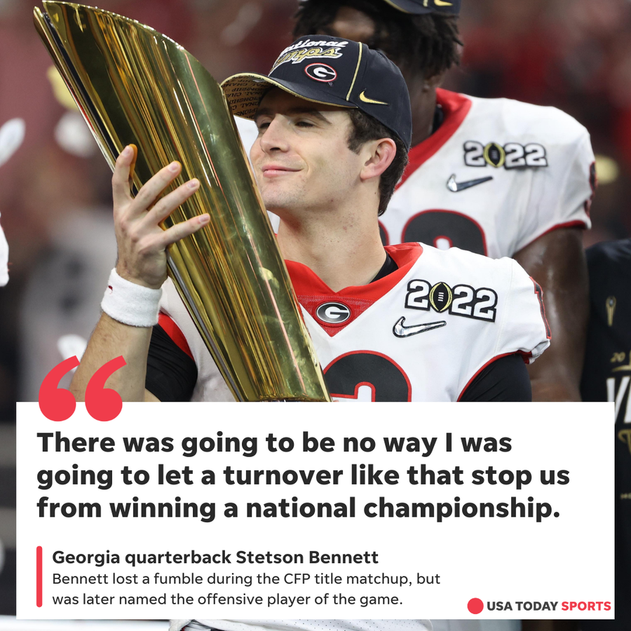 Georgia quarterback Stetson Bennett celebrates with the championship trophy after defeating  Alabama during the 2022 CFP title game on Monday night in Indianapolis.