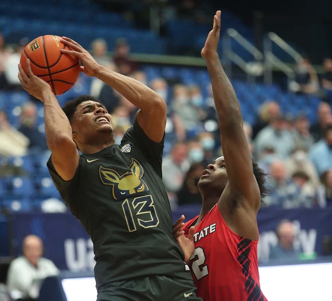 University of Akron guard Xavier Castaneda goes up for two points and is fouled by Ball State's Jaylin Sellers during the first half of the Zips; 84-74 win Tuesday night at Rhodes Arena. [Karen Schiely/Beacon Journal]