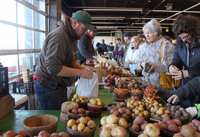 Visser Farms sells produce inside the Civic Center during the Holland Farmers Market — winter edition.