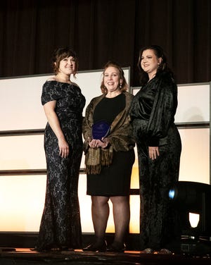 Oak Ridge Chamber of Commerce board member Sharon Kohler, center, presents the Entrepreneur of the Year Award to Leah Hunter, left, and Amanda Lovegrove, right, of The Houndry.