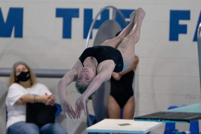 Pueblo West’s Hailey Garner flips back on her third dive at the dual against Pueblo Central on Tuesday, January 11, 2022.