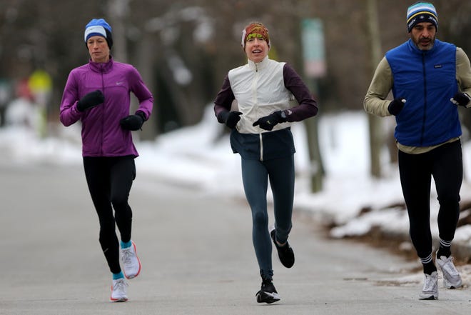 Roberta Groner (center), runs between Alexandra Niles (purple top), and Brad Barket (blue top), in Montclair, during her last long run (15 miles) before the Houston Marathon.  Groner, 44, will try to qualify for the 2024 Olympic Trials.  To do so she will have to run the 26.2. mile course in 2:37 or faster. Sunday, January 9, 2022