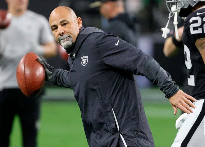 Interim head coach/special teams coordinator Rich Bisaccia of the Las Vegas Raiders goes through a drill with players as they warm up before their game against the Los Angeles Chargers at Allegiant Stadium on Sunday, Jan. 9, 2022 in Las Vegas. The Raiders defeated the Chargers 35-32 in overtime.