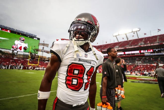 Cameron Corbett, of Magnolia, stands with Gatorade bottles behind receiver Antonio Brown during a preseason game this season while interning with the Tampa Bay Buccaneers. Corbett said Brown was a mentor to him while in Tampa.