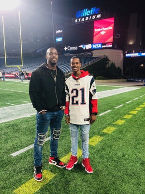 Former New England Patriot Duron Harmon (left) poses with his cousin, Cameron Corbett, at Gillette Stadium in Massachusetts on Oct. 14, 2018 after the Patriots hosted the Kansas City Chiefs.