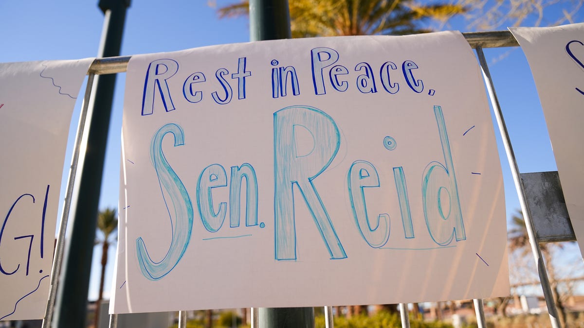 Signs commemorating former Senate Majority Leader Harry Reid hang outside the Smith Center during his memorial service on Saturday, Jan. 8, 2022, in Las Vegas.