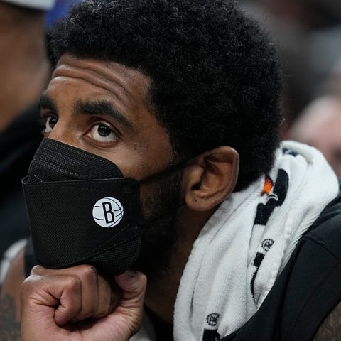 Brooklyn Nets' Kyrie Irving watches during the fir