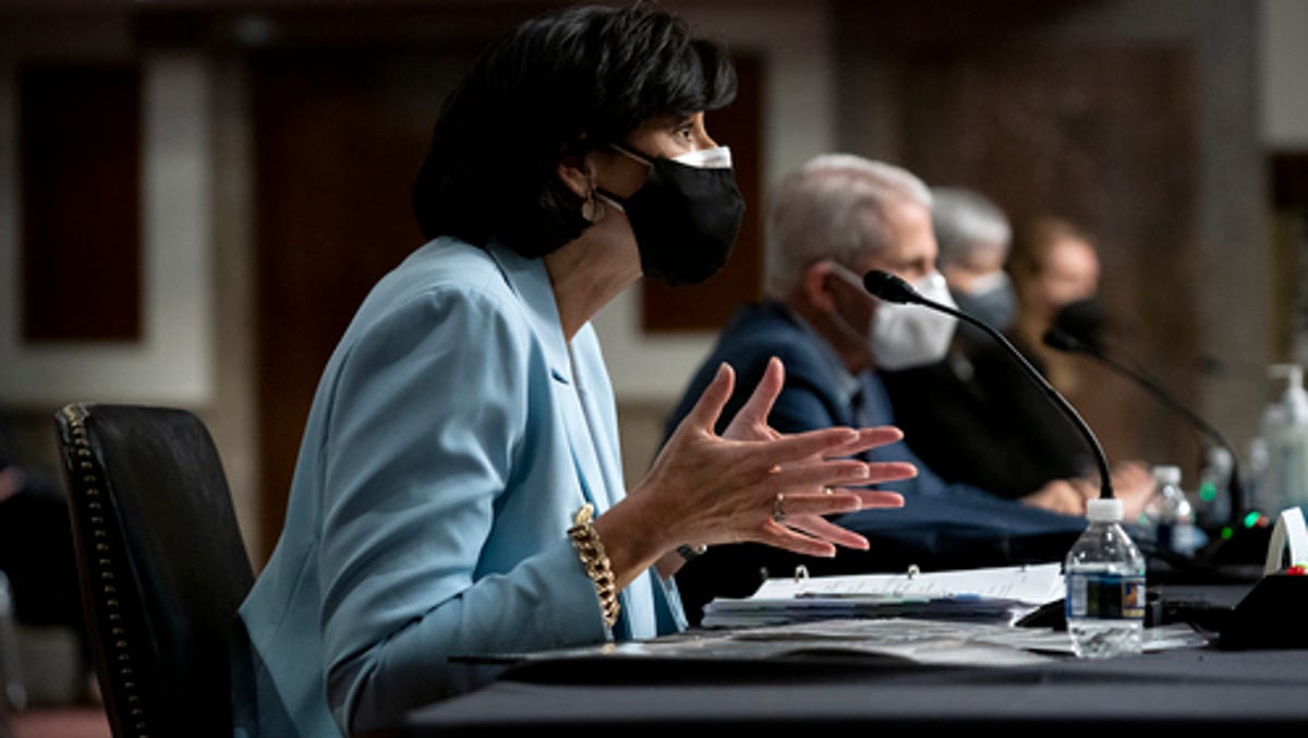 Dr. Rochelle Walensky, Director of the Centers for Disease Control and Prevention, left, and Dr. Anthony Fauci, director of the National Institute of Allergy and Infectious Diseases and chief medical adviser to the president, testify before a Senate Health, Education, Labor, and Pensions Committee hearing to examine the federal response to COVID-19 and new emerging variants, Tuesday, Jan. 11, 2022 on Capitol Hill in Washington.