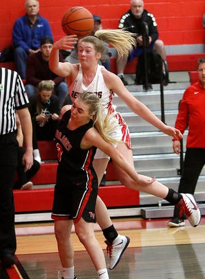 Loudonville High School's Corri Vermilya (2) leaps over Tuscarawas Valley High School's Chloe Salapack (3) to save a ball from going out of bounds during high school girls basketball action Wednesday, Jan. 12, 2022 a Loudonville High School. TOM E. PUSKAR/TIMES-GAZETTE.COM