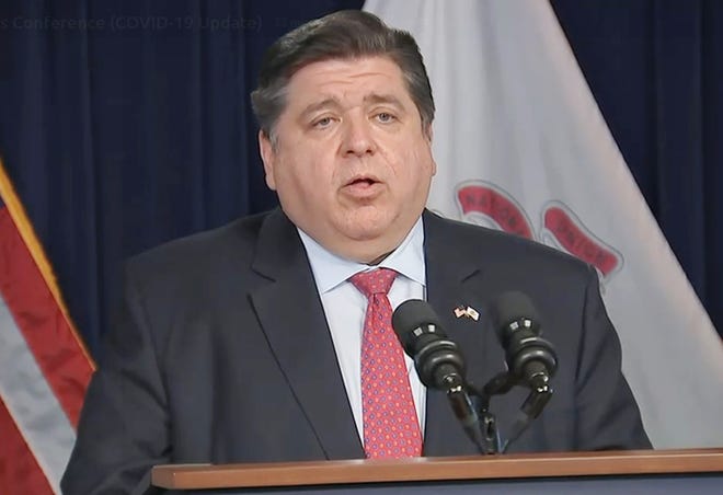 Gov. JB Pritzker gives an update on the surge in COVID-19 cases during a news conference Wednesday in Chicago.