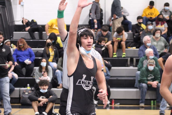 Isaiah Algien raises his hand in victory after advancing to the semi-finals of the South Colt Classic held on Jan. 8, 2022