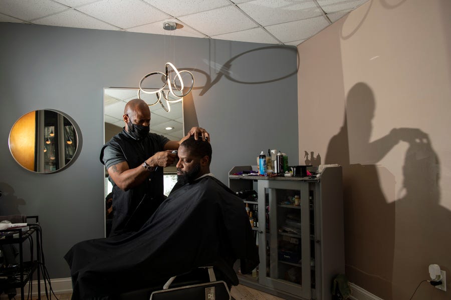 Barber Chykeat Goodley works on his customer Michael Hargrove Wednesday, Jan. 12, 2022 at New Levelz in Norristown, Pa.