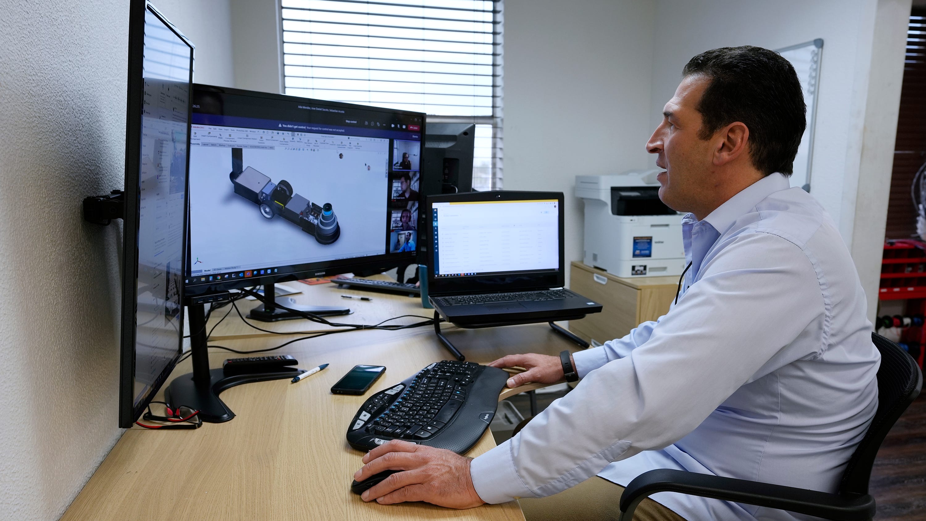 Chris Rourk works virtually with his engineering team of the Volta ION on Jan 13, 2022, in Hialeah, Florida. He struggled initially to get financing for his company, Volta Ion, which makes jacks that use clean energy and are wireless.