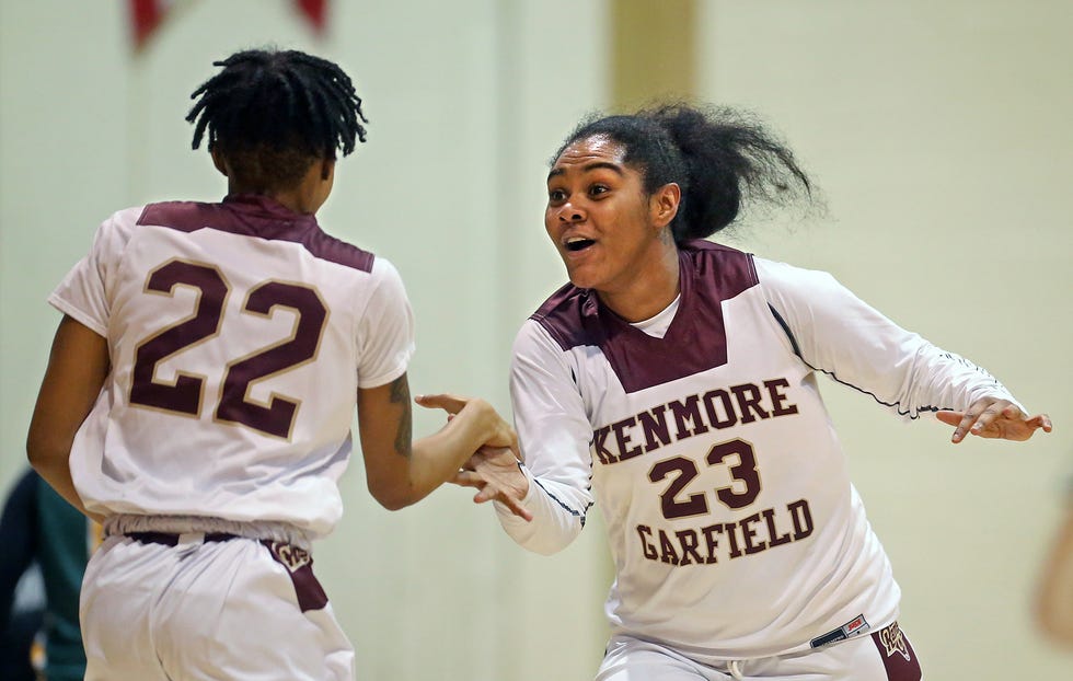 Kenmore-Garfield's Quimari Shelton, facing, celebrates with Ceazia Watson as the Rams lead during the second half of a basketball game against Firestone on Thursday in Akron.