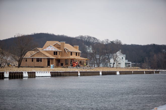 New luxury homes are under construction Thursday, Jan. 13, 2022, near 66th Street in Saugatuck. The new housing development has been challenged in the courts by environmental groups.
