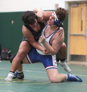 Romeo Maqueyal of GlenOak (L) has control of Anthony Miller of Lake in their 285 pound match at GlenOak Thursday, January 13, 2022. 
