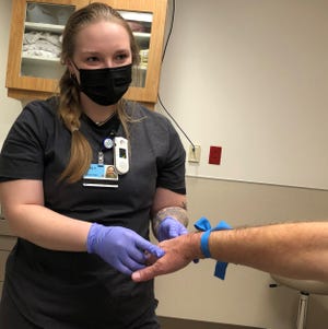 Pvt. 1st Class Gabrielle Cales, a member of the Ohio National Guard, assisted staff in the emergency center at Cleveland Clinic Union Hospital in Dover this week as part of a deployment to help Ohio hospitals during the COVID-19 pandemic.