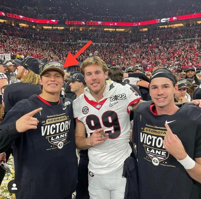 Ennis' Collin Drake (left) poses with two of his teammates on the field after the Georgia Bulldogs beat the Alabama Crimson Tide, 33-18, in Indianapolis on Jan. 10 to win the college football national championship. Drake is a true freshman walk-on quarterback.