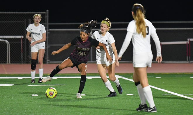 Oxnard's Sienna Pimentel controls the ball while being defended by Ventura's Esja Moore during the Yellowjackets' 3-2 victory on Thursday in a Pacific View League match.