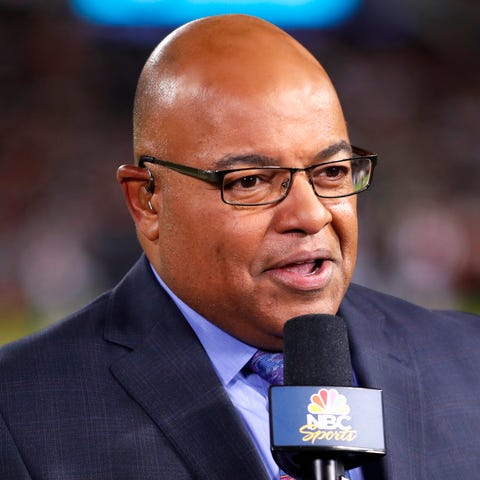 Mike Tirico works the sidelines during Sunday nigh