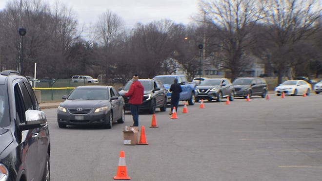 Cars line up to receive free COVID-19 at-home tests distributed Saturday by Akron City Council at the Summit Lake Community Center.
