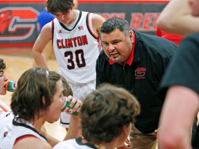 Clinton head coach Jeremy Chavez talks to his team during a timeout in Friday's game against Dundee. [Telegram photo by John Discher]