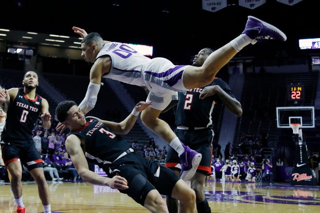 Kansas State guard Mike McGuirl collides with Texas Tech guard Clarence Nadolny while attempting to score during the second half Saturday in Manhattan, Kan.