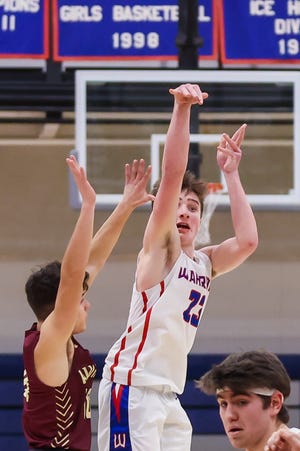 Winnacunnet's Josh Schaake gets off his game-winning, buzzer-beating 3-pointer over Alvirne's Anthony Ferullo in Friday's Division I boys basketball game. Schaake's 3-pointer at the buzzer gave the Warriors a 36-35 win.
