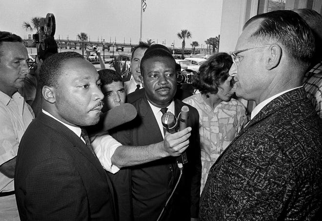 On June 12, 1964, Monson Motor Lodge manager James Bullock (right) stops Dr. Martin Luther King Jr. (left) and Reverend Ralph Abernathy at the motel restaurant door. The integrationist was arrested when he refused to leave the facility.