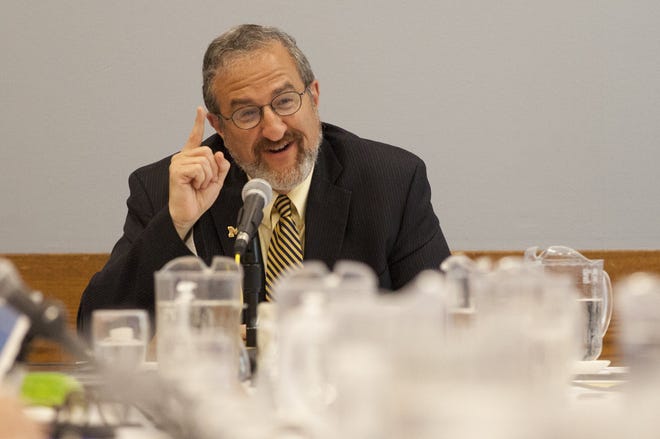 University of Michigan President Mark Schlissel makes a joke in July 2014 during his first regents meeting in Ann Arbor.