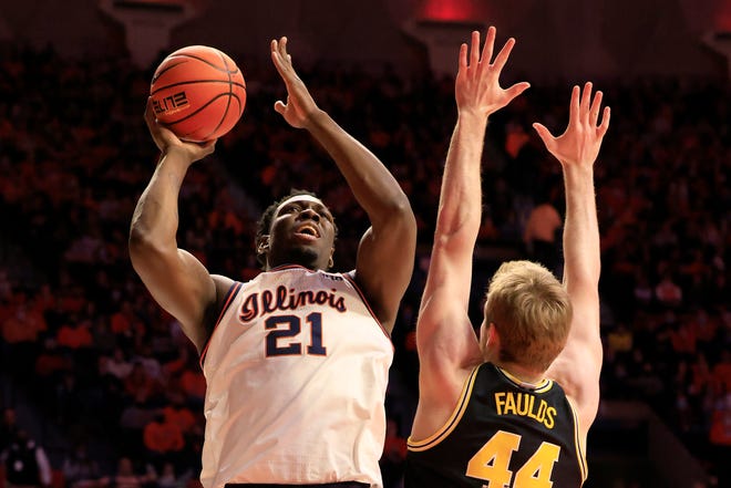Kofi Cockburn of the Illinois Fighting Illini takes a shot while guarded by Jaron Faulds of the Michigan Wolverines during the first half at State Farm Center in Champaign, Illinois, on Friday, Jan. 14, 2022.
